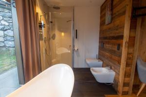 a bathroom with two toilets and a shower and a sink at Chalet Dinkel in Niedernsill in Niedernsill