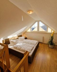 a bedroom with a large bed in a attic at Strandstr_ in Zingst