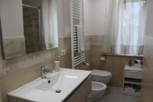 a bathroom with a sink and a toilet at Il silenzio delle colline Umbre - Vicino Todi in Todi +86 photos