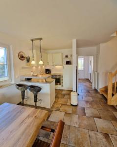 a kitchen with a table and some chairs in a room at Strandstr_ in Zingst