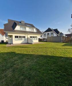 a house with a large yard in front of it at Strandstr_ in Zingst