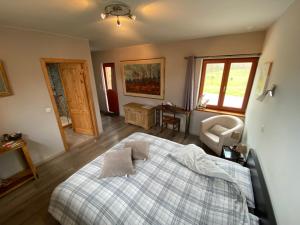 a bedroom with a bed and a chair in it at Forges de Pernelle in Couvin