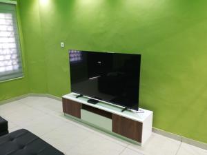 a flat screen tv sitting in a living room at Eldu Villa in Kokrobite