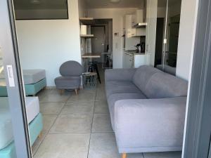 a living room with a couch and a chair at Cloche d'or in Luxembourg
