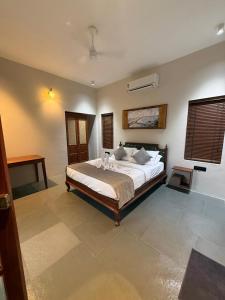 a bedroom with a large bed in a room at Nilah Private Pool Villa in Kappil