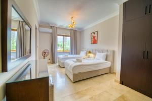 a hotel room with two beds and a window at Sunset Poseidon by Carrington in Kyrenia +190 photos