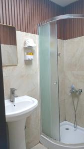 a bathroom with a shower and a sink at Deira Guest house by PHM in Dubai