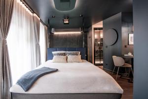 a bedroom with a large bed and a window at La Suite Bleue in Cholet
