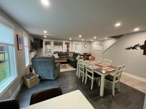 a living room with a table and a couch at Mountain bike Ski Eville Mecca in Ellicottville