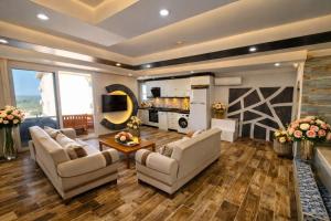 a living room with two couches and a table at Patara Evleri in Patara
