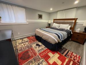 a bedroom with a bed and a rug at Mountain bike Ski Eville Mecca in Ellicottville