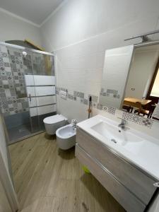 a bathroom with a sink and a toilet and a mirror at Mono perfetto per Ospedale e Treni Check-in rapido in Livorno +16 photos