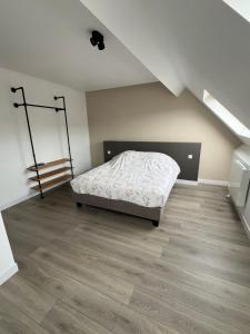 a bedroom with a bed in a attic at L'Arsenal Loft in Couvin