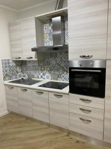 a kitchen with a sink and a stove at Mono perfetto per Ospedale e Treni Check-in rapido in Livorno