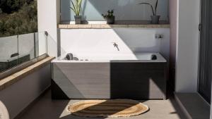 a bathroom with a sink and a bath tub at Villa Filothea with Jacuzzi & SV by CorfuEscapes in Spartýlas +54 photos