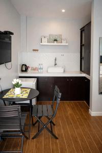a kitchen with a table and a sink and a counter at Point Gate Inn in Bacolod