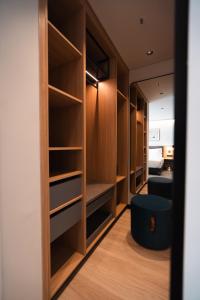 a walk in closet with a blue stool in a room at Alt Life Stays - Manyata Tech Park in Bangalore