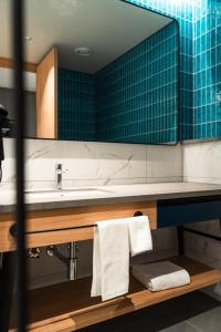 a bathroom with a sink and a mirror at Alt Life Stays - Manyata Tech Park in Bangalore