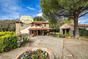 a building with a sign on top of it at Locanda il Boschetto in Volterra