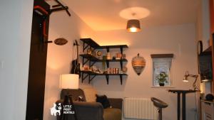 a living room with a couch and shelves on the wall at Charming 1-Bed with Private Parking & Full Bath in Dunstable