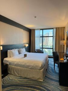 a hotel room with a bed and a large window at Elaf Al Sagryah Hotel in Mecca +52 photos
