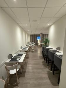 a row of tables and chairs in a dining room at Confidence Hotel Europa in Cento