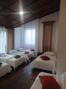 a group of beds in a room with windows at Star Gate Hostel in Nuwara Eliya +3 photos