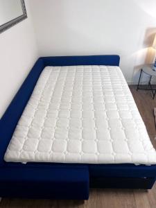 a mattress on a bed frame in a room at Apartment CentrumMitte Anger in Erfurt