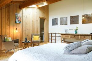 a bedroom with a bed and a table and chairs at Le Presbytère de Bugarach in Bugarach