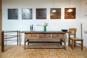 a room with a wooden table and two chairs at Le Presbytère de Bugarach in Bugarach