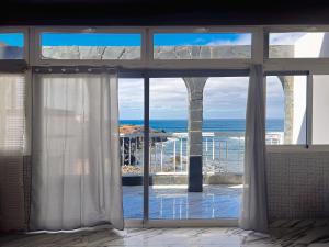 a view of the ocean from a room with a window at Paradise in El Cotillo in El Cotillo