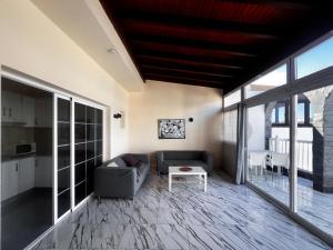a living room with a couch and a table at Paradise in El Cotillo in El Cotillo
