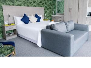 a bedroom with a large bed and a couch at McAllisters on 8th in Durban +14 photos