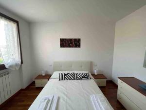 a bedroom with a large white bed in a room at Bella Ciao Airport Apartment in Seriate