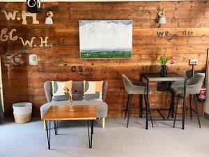 a living room with two chairs and a table at The Old Workshop in St Ives +13 photos