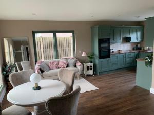 a living room with a couch and a table at Kerry Coastal Hideaway in Fenit