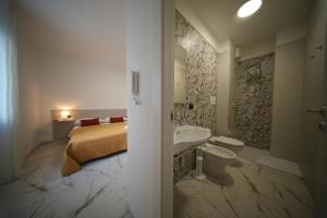 a bathroom with a bed and a sink and a toilet at La Casa Di Nonna in Licusati +54 photos