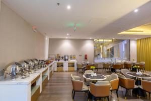 a restaurant with tables and chairs in a room at Al Muahidb Residence Al Takhasossi 4 - Economic in Riyadh