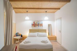 a bedroom with a large bed and a table at Hotel Centrale in Syracuse +83 photos