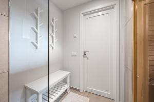 a walk in closet with a glass door at Metsa terraced house in Haapsalu