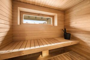 a sauna with a bench in a wooden room at Metsa terraced house in Haapsalu
