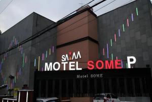 a building with a sign on the side of it at Motel Some in Suwon
