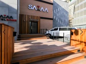 a building with a van parked outside of a building at Motel Some in Suwon