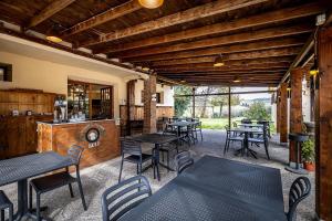 a patio with tables and chairs in a restaurant at Locanda il Boschetto in Volterra