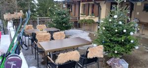 a patio with christmas trees and tables and chairs at Alpwirtschaft Heirihütte in Rigi Klösterli