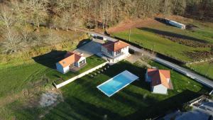 an aerial view of a house with a swimming pool at Quinta das Candeias - Casa da Bé in Arcos de Valdevez