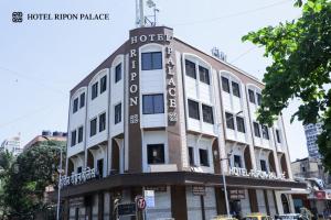 a building with a sign on the side of it at Hotel Ripon Palace in Mumbai
