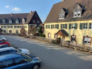 a row of houses and cars parked on a street at Apartment Erzgebirgsperle in Schwarzenberg