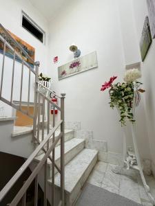 a staircase with a vase of flowers in a room at Almasol in Cassano delle Murge +34 photos