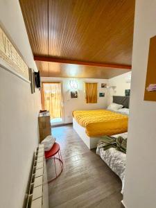 a bedroom with two beds and a wooden ceiling at Almasol in Cassano delle Murge
